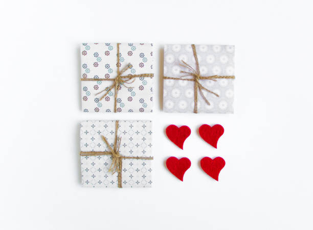 istock Rustic handmade gift boxes decorated with hearts on white background. Top view, flat lay 653126686