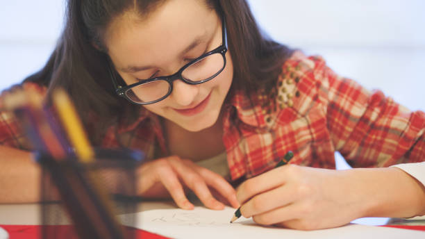 istock Teenage girl doing homework 653127218