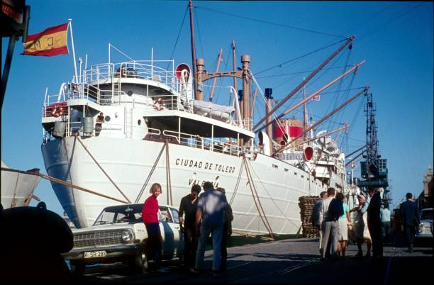 Barcelona, Catalonia, Spain, 1969. The port of Barcelona. Traveling waiting for the shipping of their vehicles to the Cuidad de Toledo.