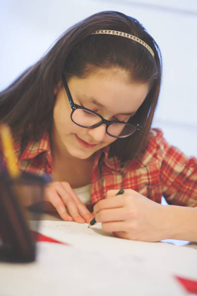 istock Teenage girl doing homework 653127480