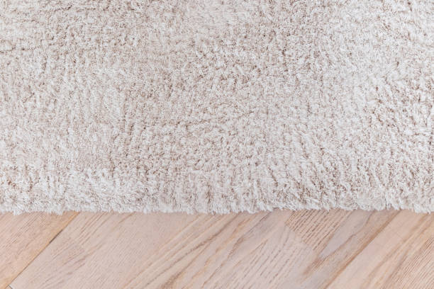 istock beige soft carpet and parquete floor 653134800