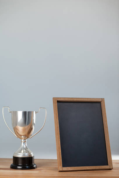 istock Trophy and chalkboard on wooden table 653142094