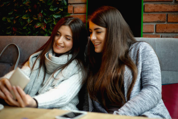 istock Two beautiful women taking selfie in cafe 653142708