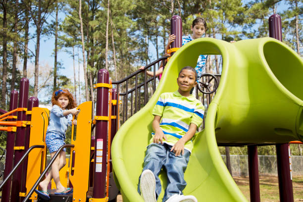 istock Multi-ethnic elementary school children playing on playground at park. 653143106