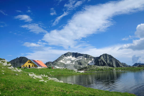 Tevno Lake in Pirin Mountain with a beautiful sky and hut