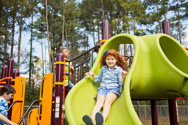 istock Multi-ethnic elementary school children playing on playground at park. 653146000