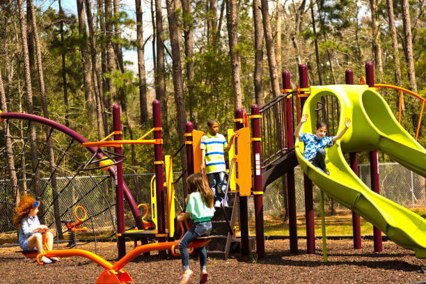 istock Multi-ethnic elementary school children playing on playground at park. 653146650