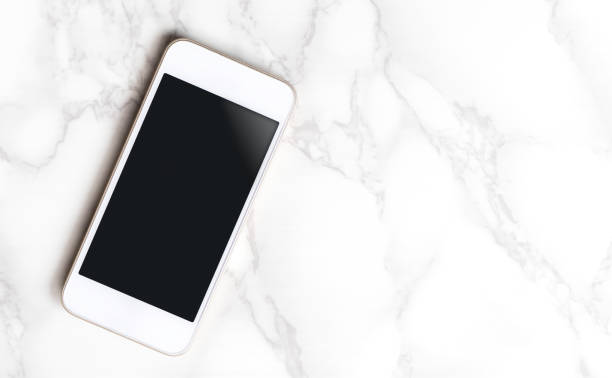 istock Luxury White Gold smartphone on marble table with copy space 653146756