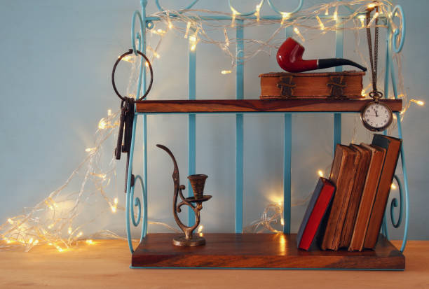 istock Classical shelf with vintage male objects and garland lights 653149478
