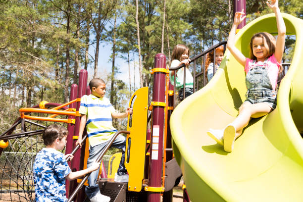 istock Multi-ethnic elementary school children playing on playground at park. 653149506