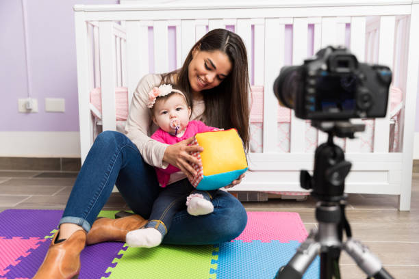 istock Mom and baby recording a video 653150344