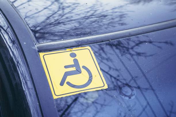 istock Disabled sign on the car glass. 653155602