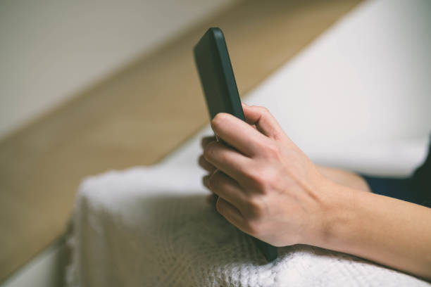 istock Beautiful girl is using a digital tablet and smiling while sitting on the couch at home 653155788