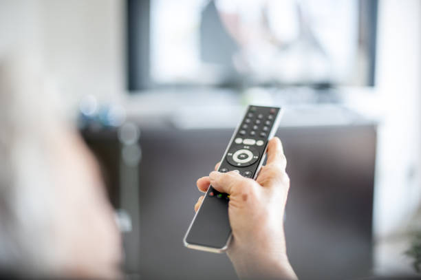 istock Close Up Hands Of Senior Woman Using TV Remote Control 653161300