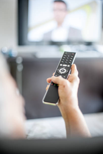 istock Close Up Hands Of Senior Woman Using TV Remote Control 653161304