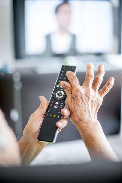 istock Close Up Hands Of Senior Woman Using TV Remote Control 653161308