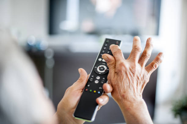 istock Close Up Hands Of Senior Woman Using TV Remote Control 653161314
