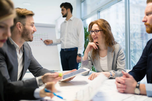 istock Group of business people collaborating on project  in office 653161402
