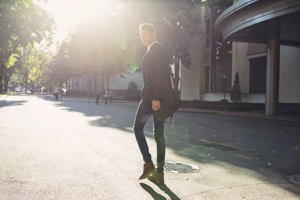 istock Hipster man walking in the streets 653164480