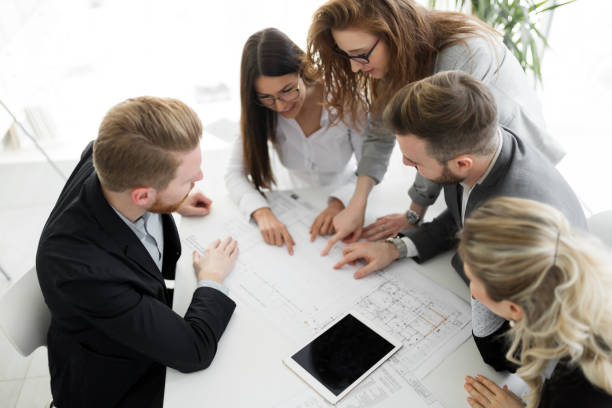istock Business people and architects collaborating on business project 653164492