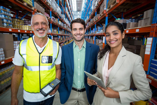 istock Portrait of warehouse team standing with digital tablet and barcode scanner 653171078