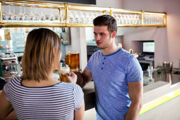 istock Couple drinking beer by counter 653177660