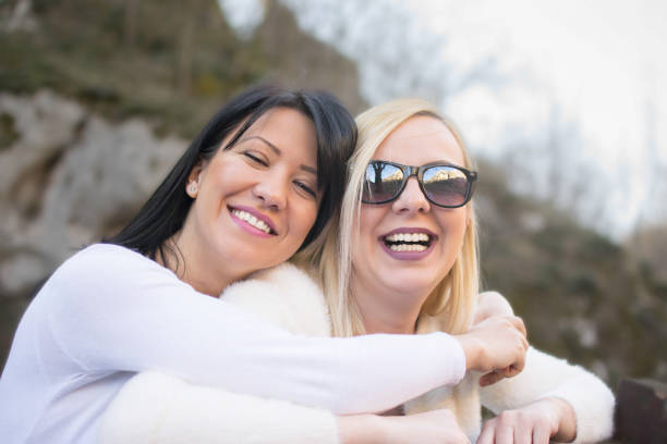 Two teenagers laughing at the park