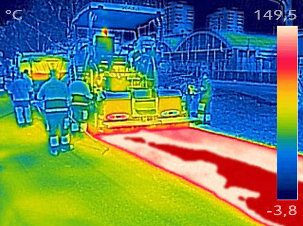 istock Infrared thermovision image Workers on Asphalting Road street 653181060