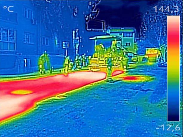 istock Infrared thermovision image Workers on Asphalting Road street 653181100