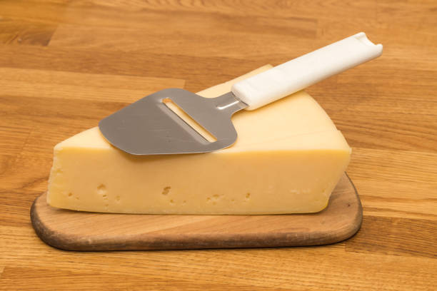 istock Piece of cheese with a slicer 653187858