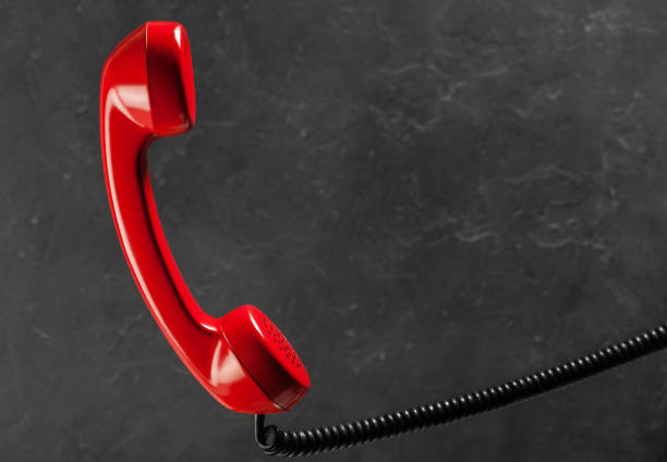istock landline red phone on a gray wall background 653188328