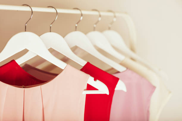Women's clothing in pink tones on a white hanger. Selective focus.