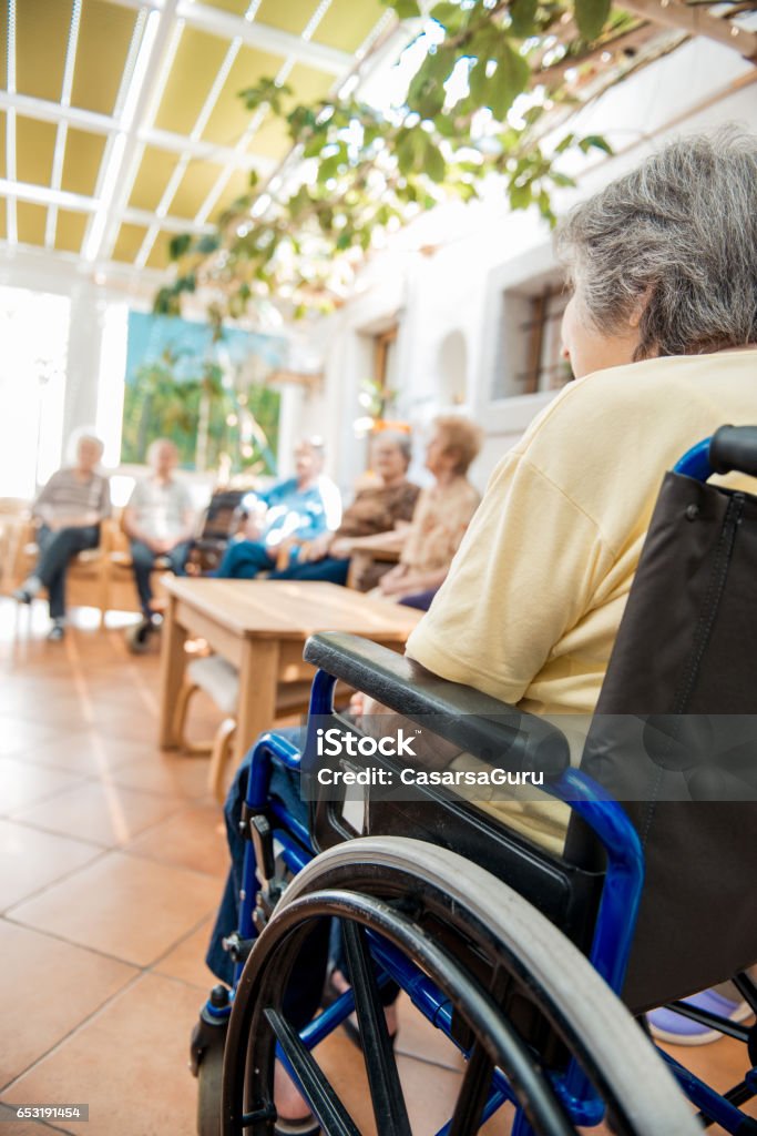 Seniors Socializing In The Hall Of The Retirement Center A Helping Hand Stock Photo