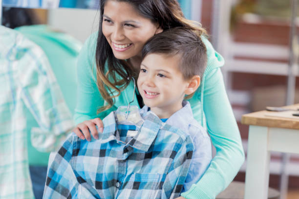 cheerful mom shops with young son - boutique shopping retail mother imagens e fotografias de stock