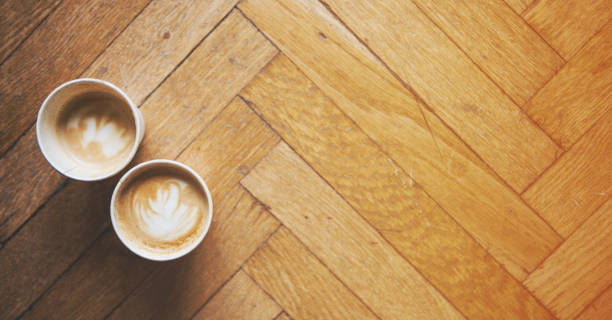 istock Two coffees on a floor background and a warm atmosphere 653191898