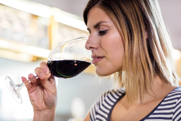 istock Young woman drinking wine at restaurant 653194970