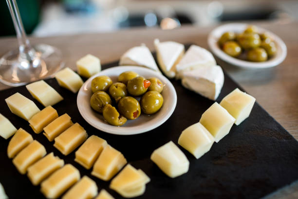 High angle view of cheese slices and olives on tray at restaurant