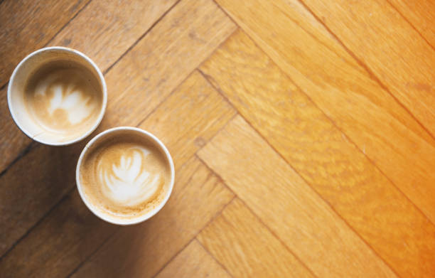 istock Two coffees on a floor background and a warm atmosphere 653198548