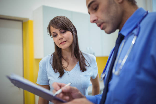 istock Doctor interacting with patient and writing on clipboard 653198690
