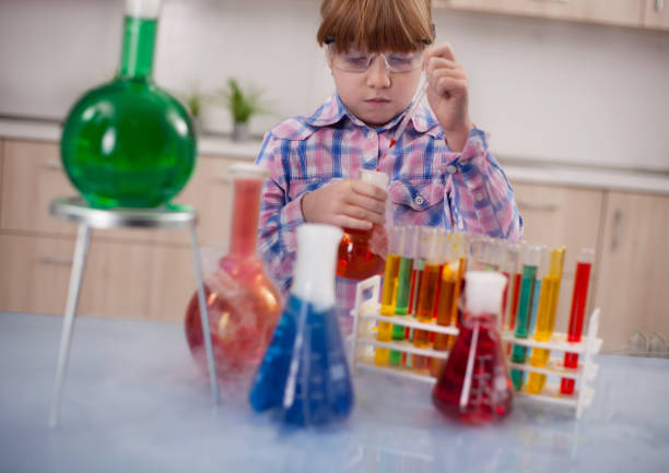 istock girl doing experiments in the laboratory,Science and education concept 653205876