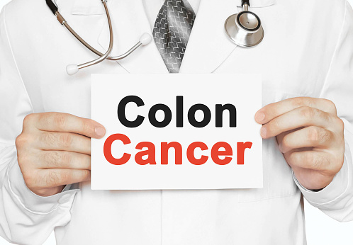 Doctor holding a card with Colon Cancer, Medical concept