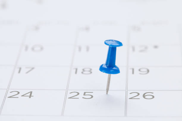 istock blue pin on White Calendar Closeup shot 653221800