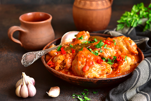 Chakhokhbili - chiken stew with cilantro (parsley) in tomato sauce in a clay bowl,traditional dish of georgian cuisine
