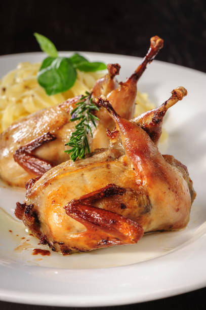 istock Rosted or fried quail with herbs and tagliatelle 653225322