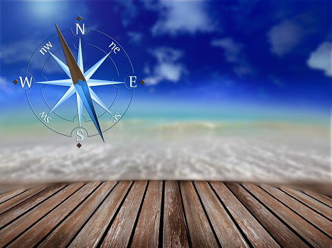 blurred background of sea and compass in beach