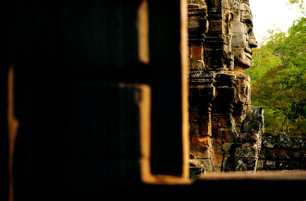 The towers of the Bayon Temple, big faces are carved into the upper sandstone bricks, Angkor Wat, Siem Reap, Cambodia 2023