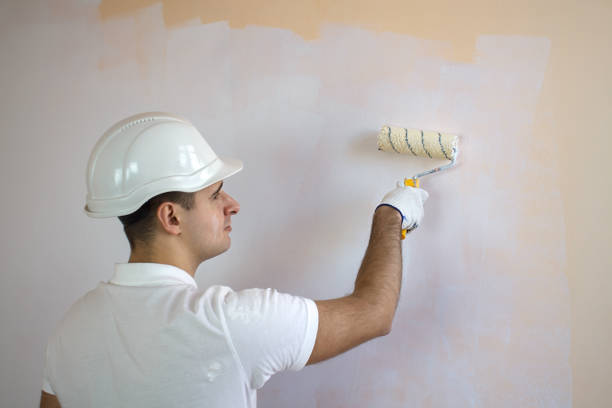 istock Close up view of man holding paint roller 653237232