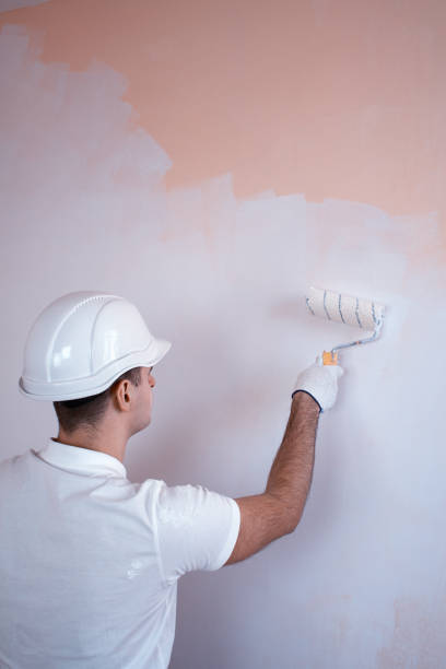 istock Close up view of  man holding paint roller 653237268