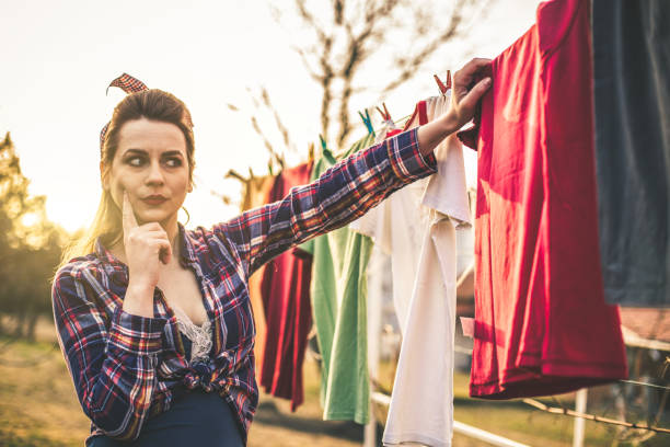 istock Vintage style lady doing laundry outdoors 653242234