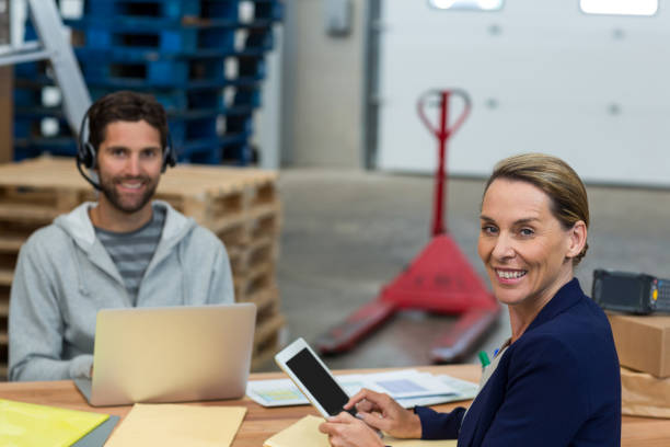 istock Portrait of warehouse managers using digital tablet and laptop 653244890
